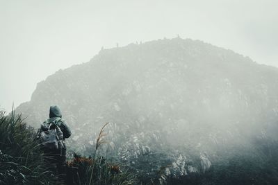 People on mountain against sky