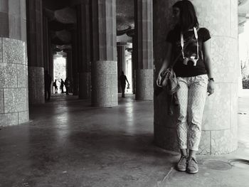 Woman standing in corridor of building