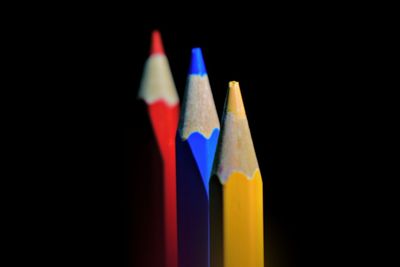 Close-up of colored pencils against black background