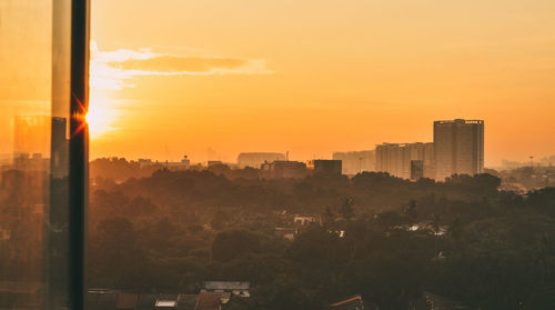 Cityscape against sky during sunset