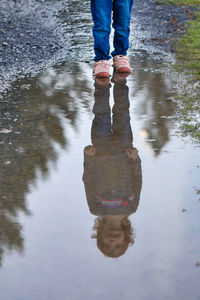 Low section of girl at puddle