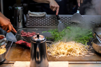 Midsection of man preparing food in kitchen