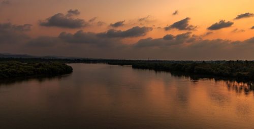 Scenic view of lake against sky at sunset