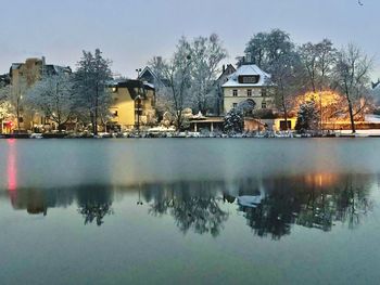 Reflection of trees and buildings in lake