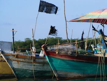 Boats moored on sea against sky