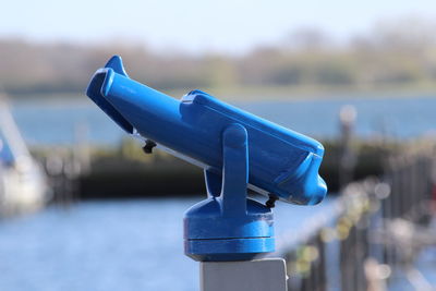 Close-up of blue metallic coin-operated binoculars