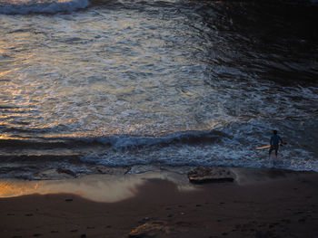 Man standing on beach against sky