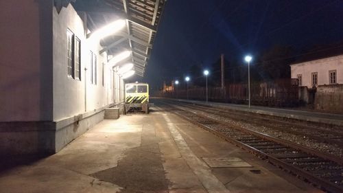 View of illuminated railroad station platform at night