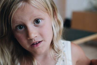 Close-up portrait of cute girl at home