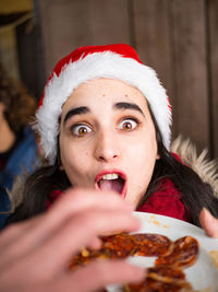 Close-up of woman having food during christmas