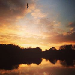 Scenic view of lake against sky during sunset