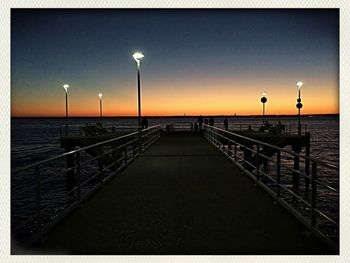 Pier on sea at sunset