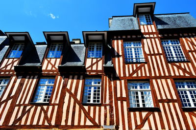 Low angle view of residential building against blue sky