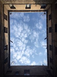 Low angle view of building against cloudy sky