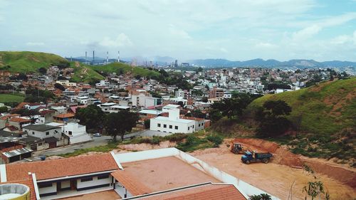 View of cityscape against cloudy sky