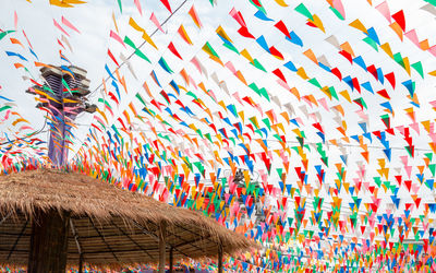 Multi colored umbrellas hanging on roof of building