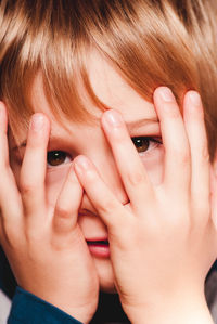 Close-up portrait of boy with hands