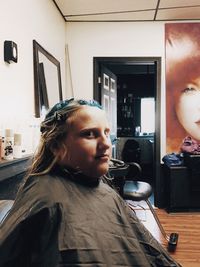 Portrait of young man looking away at home