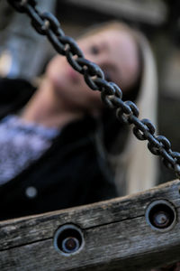 Close-up of chain on wood