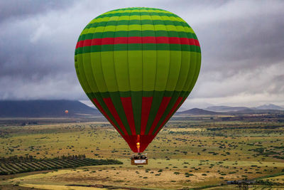 Hot air balloons flying over field