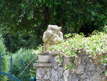 Statue against trees