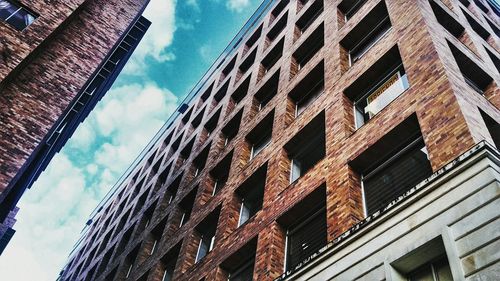 Low angle view of building against cloudy sky