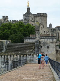 Rear view of women walking on historical building