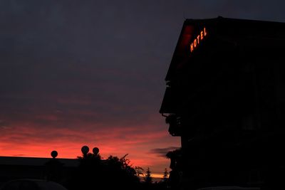 Low angle view of hotel building against sky during sunset