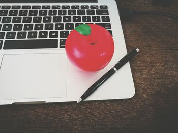 Close-up of red heart shape on laptop