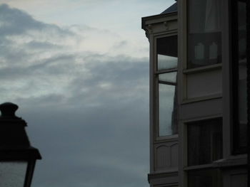 Low angle view of building against cloudy sky