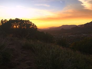 Scenic view of land against sky during sunset