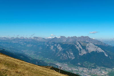 Scenic view of mountains against clear blue sky