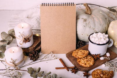 Autumn composition mockup, cocoa, marshmallows, cookies, pumpkin and candles.