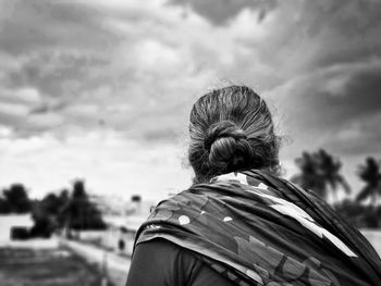 Rear view of woman against sky
