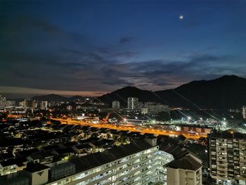 High angle view of illuminated buildings in city at night