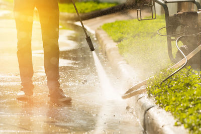 Low section of man splashing water