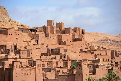 Old buildings in city against sky