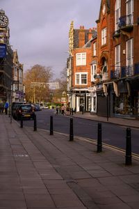 Street amidst buildings in city against sky