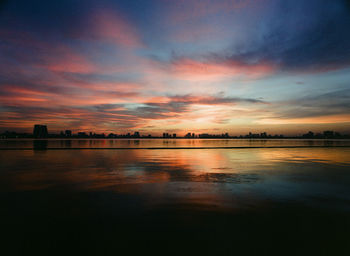 Scenic view of lake against sky during sunset