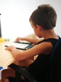 Side view of boy using mobile phone