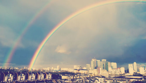 Idyllic shot of rainbow over cityscape