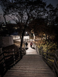People walking on bridge against sky