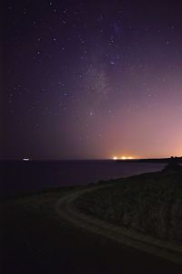 Scenic view of landscape against star field