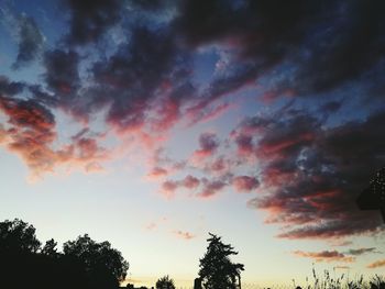 Low angle view of silhouette trees against sky at sunset