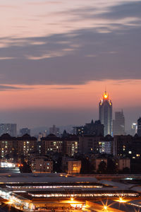 High angle view of illuminated city at sunset