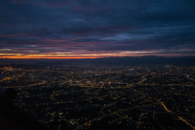 Aerial view of city against sky during sunset