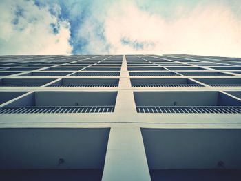 Low angle view of building against cloudy sky