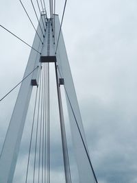 Low angle view of suspension bridge against sky