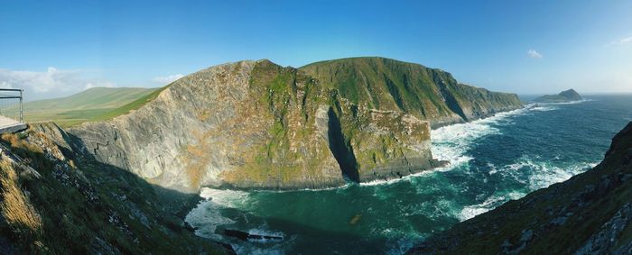 Panoramic view of sea and mountains against sky