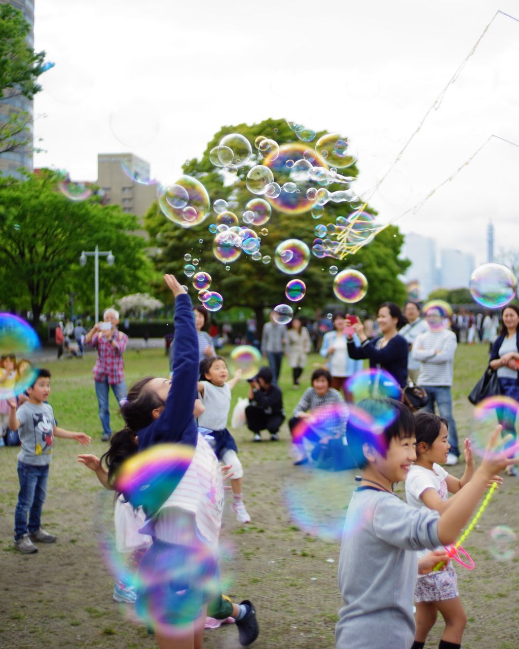 large group of people, leisure activity, lifestyles, celebration, person, enjoyment, fun, crowd, men, togetherness, mixed age range, multi colored, arts culture and entertainment, enjoying, girls, event, balloon, tree, day